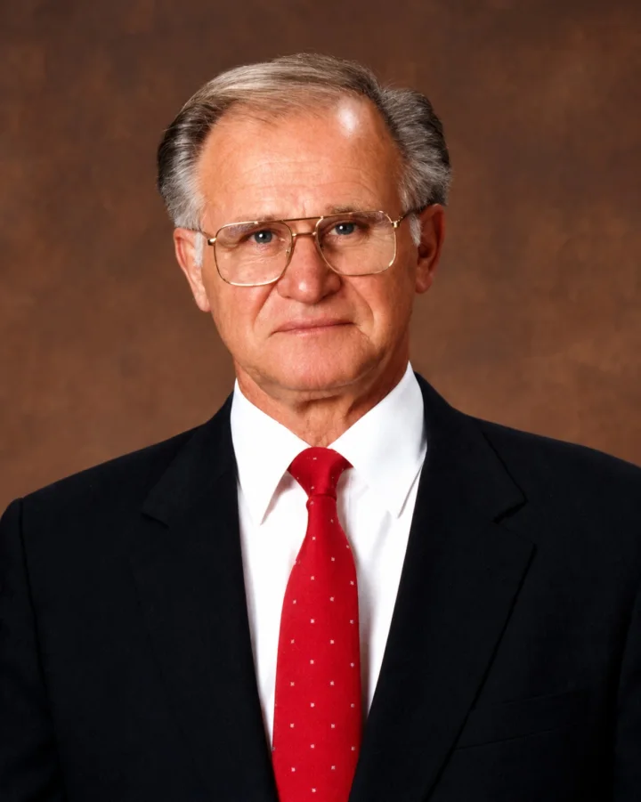 Jack Yancick wearing a dark suit and red tie